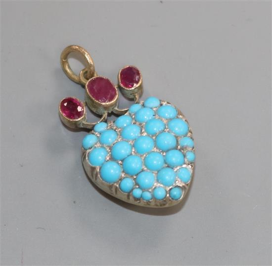 A yellow and white metal, three stone ruby and turquoise encrusted heart shaped pendant, 21mm.